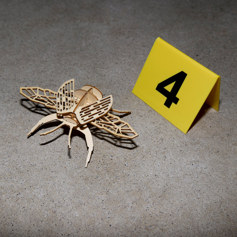 A stenciled out wooden puzzle, 3 dimensional. Wings are spread.
