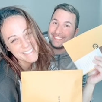 Lauren Korellis and her teammate holding cases on Hunt A Killer