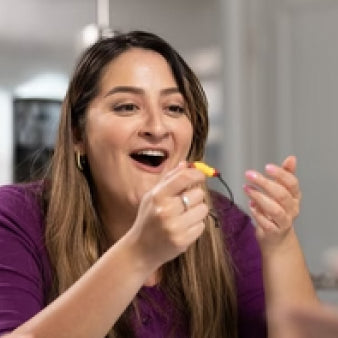 A female player holding a bracelet on Hunt A Killer